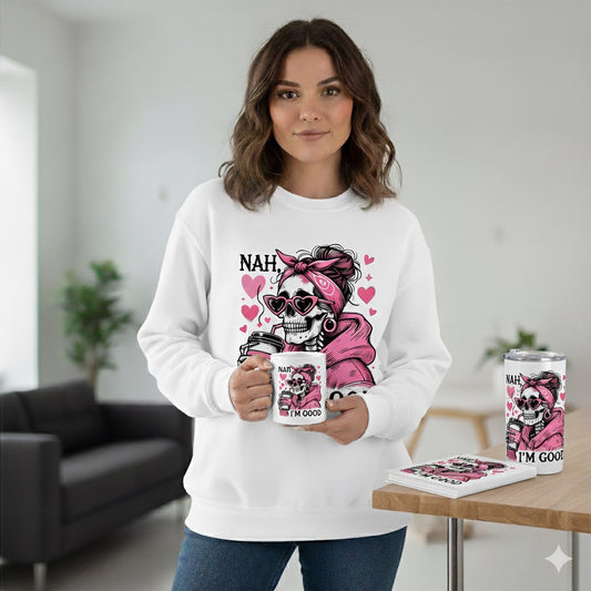 Woman wearing a white sweatshirt with a graphic design, holding a mug in a room.