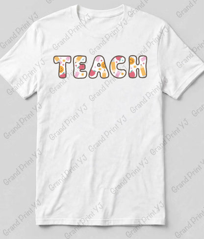 A white short-sleeve crewneck t-shirt featuring the word 'TEACH' printed across the chest in a retro, wavy font filled with a colorful floral pattern of pink, orange, yellow, and white. The t-shirt is displayed flat against a light gray background with diagonal watermarks.