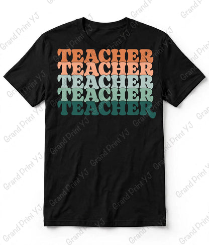 A black short-sleeve t-shirt with a retro-style stacked graphic reading 'TEACHER' in orange, peach, light blue, mint green, and teal lettering, displayed flat against a white background with diagonal watermarks.