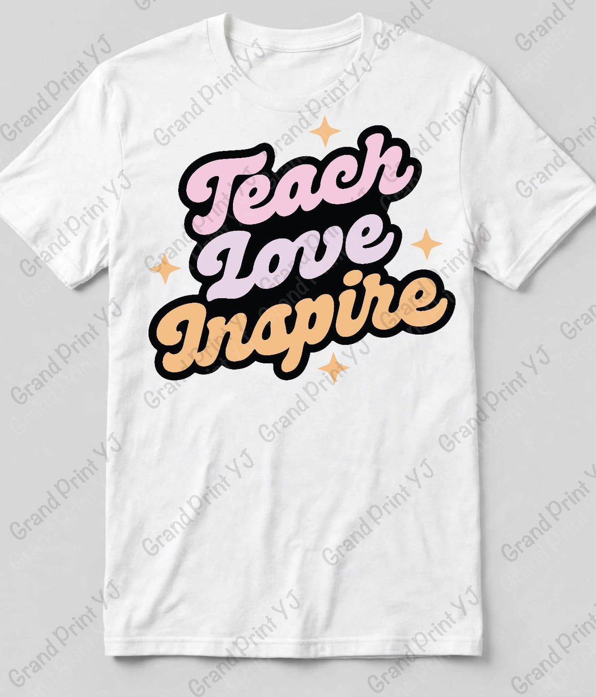 A white short-sleeve t-shirt with a retro-style graphic reading 'Teach Love Inspire' in pink, purple, and peach bubble letters with black outlines and small peach stars, shown on a light gray background with a faint Grand Print YJ watermark.