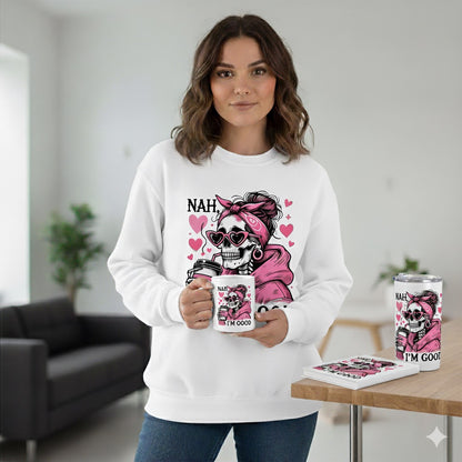 Woman wearing a white sweatshirt with a graphic design, holding a mug in a room.