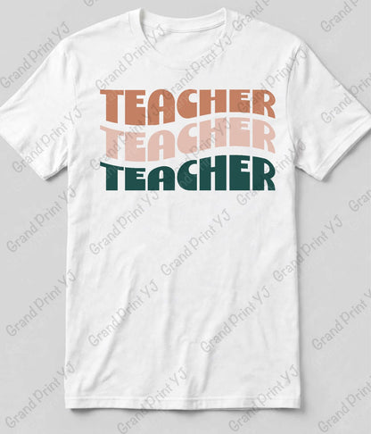 A white short-sleeve crewneck t-shirt featuring a stacked graphic text design that reads 'TEACHER TEACHER TEACHER' in retro-style block letters. The top two lines are in muted orange and light pink, while the bottom line is in dark teal.